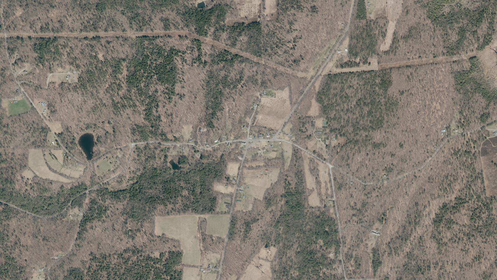 Aerial view of a Franklin County hilltown centre surrounded by woodland